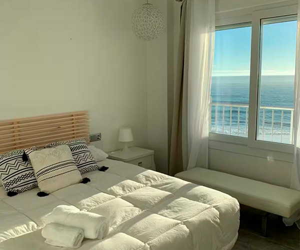 habitacion con cama doble con vistas al mar